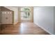 Bright, airy living room with hardwood floors, a large window, and double door entry at 2882 Signal Creek Dr, Thornton, CO 80241