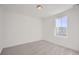 Spacious bedroom featuring a large window and grey carpet at 5553 Wisteria Ave, Firestone, CO 80504