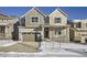 Two-story house with light beige siding, gray accents, and a large front yard at 5553 Wisteria Ave, Firestone, CO 80504