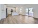 Modern kitchen featuring white cabinets, an island, and vinyl plank flooring at 5553 Wisteria Ave, Firestone, CO 80504