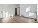 Laundry room with white cabinets, vinyl plank flooring, and built-in shelving at 5553 Wisteria Ave, Firestone, CO 80504