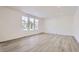 Bright living room featuring vinyl plank flooring and large windows at 5553 Wisteria Ave, Firestone, CO 80504