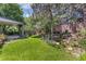 Expansive backyard features lush lawn, stone waterfall, and covered deck perfect for outdoor entertaining at 6429 S Jamaica Cir, Englewood, CO 80111