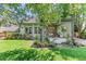 Secluded backyard featuring a covered patio, lush landscaping, and inviting outdoor space at 6429 S Jamaica Cir, Englewood, CO 80111