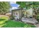 Landscaped backyard with a covered patio, grill, and a lush green lawn at 6429 S Jamaica Cir, Englewood, CO 80111