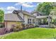 Expansive backyard showcasing the home's covered patio, lush lawn, and mature landscaping at 6429 S Jamaica Cir, Englewood, CO 80111