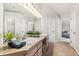 Bright bathroom with dual sinks, vanity, mirrors, and access to bedrooms at 6429 S Jamaica Cir, Englewood, CO 80111