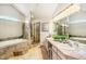 Luxurious bathroom features soaking tub, glass shower, and double vanity at 6429 S Jamaica Cir, Englewood, CO 80111