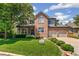 Stately two-story brick home boasts manicured landscaping and a three-car garage at 6429 S Jamaica Cir, Englewood, CO 80111