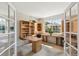 Bright home office featuring built-in shelving and large windows, creating an inviting workspace at 6429 S Jamaica Cir, Englewood, CO 80111