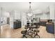 Spacious kitchen features custom cabinets, modern stainless appliances, and center island with breakfast bar at 6429 S Jamaica Cir, Englewood, CO 80111