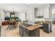 Open-concept kitchen with gas stovetop island and seamless flow into the adjoining living room at 6429 S Jamaica Cir, Englewood, CO 80111