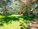 Serene backyard with a wooden deck, surrounded by mature trees offering ample shade at 15395 E Penwood Pl, Aurora, CO 80015