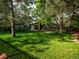 Spacious backyard and yard area featuring mature trees and landscaping at 15395 E Penwood Pl, Aurora, CO 80015