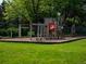 Community playground with a slide, climbing bars and lush grass surroundings at 15395 E Penwood Pl, Aurora, CO 80015
