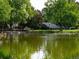 Community pond with a fountain feature bordered by lush green trees at 15395 E Penwood Pl, Aurora, CO 80015