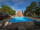 Community pool and recreation area with lounge chairs surrounded by mature shade trees at 15395 E Penwood Pl, Aurora, CO 80015