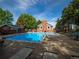 Community outdoor swimming pool and lounge area with mature trees and a blue sky backdrop at 15395 E Penwood Pl, Aurora, CO 80015