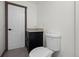 A powder room with a black cabinet, wood trim and a stone countertop sink at 46 Silver Creek Rd, Idaho Springs, CO 80452
