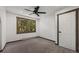 A bedroom featuring neutral walls, carpeted floors, and a window overlooking a forest at 46 Silver Creek Rd, Idaho Springs, CO 80452