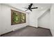 A bedroom featuring neutral walls, carpeted floors, and a window overlooking a forest at 46 Silver Creek Rd, Idaho Springs, CO 80452