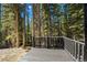 Wooden deck with a scenic backdrop of the surrounding forest, offering a peaceful outdoor space at 46 Silver Creek Rd, Idaho Springs, CO 80452