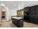 Modern kitchen with island, black cabinets, and stainless steel appliances at 46 Silver Creek Rd, Idaho Springs, CO 80452