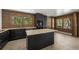 Spacious kitchen featuring a large island, dark cabinetry, and wood-paneled walls at 46 Silver Creek Rd, Idaho Springs, CO 80452