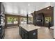 Open kitchen and living space featuring an island, wood accents, and a modern fireplace at 46 Silver Creek Rd, Idaho Springs, CO 80452