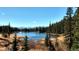 Lake view reflecting the clear skies and mountains, creating a serene and picturesque landscape at 46 Silver Creek Rd, Idaho Springs, CO 80452
