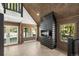 Bright living room with wooden walls, modern fireplace, and outdoor view from the double doors at 46 Silver Creek Rd, Idaho Springs, CO 80452