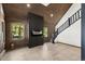 Cozy living room featuring wood paneling, modern fireplace, and staircase to the second floor at 46 Silver Creek Rd, Idaho Springs, CO 80452
