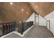 A loft area with a wood ceiling and carpeted floor with natural light at 46 Silver Creek Rd, Idaho Springs, CO 80452