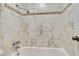 Tiled bathtub with modern fixtures at 5995 E Iliff-1 Ave # 309, Denver, CO 80222