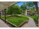 Beautifully landscaped courtyard featuring lush greenery and a sidewalk at 5995 E Iliff-1 Ave # 309, Denver, CO 80222