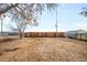 Large fenced backyard featuring a mix of dirt and grass, providing privacy and space for outdoor activities at 4210 S Dale Ct, Englewood, CO 80110