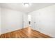 Neutral bedroom featuring hardwood floors, white walls, doors and trim, and a view of the bath at 4210 S Dale Ct, Englewood, CO 80110