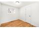 Cozy bedroom featuring hardwood floors, white walls and trim, and a window letting in sunlight at 4210 S Dale Ct, Englewood, CO 80110