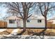 Charming single-story home with manicured front yard and white exterior, showcasing curb appeal at 4210 S Dale Ct, Englewood, CO 80110