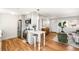 Stylish kitchen with modern appliances, breakfast bar, and easy access to living and dining areas at 4210 S Dale Ct, Englewood, CO 80110