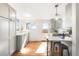 Well-lit kitchen featuring bright white countertops, gray cabinets, and an adjacent dining area at 4210 S Dale Ct, Englewood, CO 80110