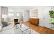 Bright living space featuring hardwood floors, contemporary design, and a seamless flow to kitchen at 4210 S Dale Ct, Englewood, CO 80110