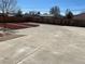 Concrete backyard featuring gravel, red mulch beds and wooden fence at 805 Park Ave, Fort Lupton, CO 80621