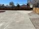 Concrete backyard featuring gravel, red mulch beds and wooden fence at 805 Park Ave, Fort Lupton, CO 80621