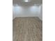 Finished basement with light walls, wood look tile flooring, and recessed lighting at 805 Park Ave, Fort Lupton, CO 80621