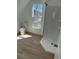 Bathroom featuring a tile shower, toilet, and window at 805 Park Ave, Fort Lupton, CO 80621