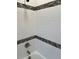 Bathroom featuring tiled walls and a tiled bathtub at 805 Park Ave, Fort Lupton, CO 80621