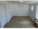 Bedroom with light walls, wood look tile flooring, and windows for natural light at 805 Park Ave, Fort Lupton, CO 80621