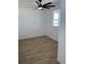 Bright bedroom with wood look tile flooring and a new ceiling fan at 805 Park Ave, Fort Lupton, CO 80621
