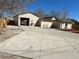 Exterior showing concrete driveway leading to open-backed garage with mulched yard at 805 Park Ave, Fort Lupton, CO 80621